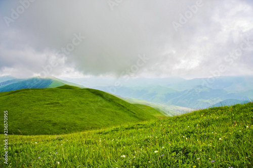 Cloud hanging over hill