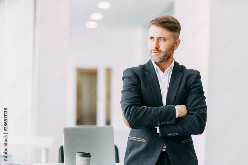 Confident emotional man at work. Bright interior with a businessman. Confident emotional man at work. Bright interior with a businessman.