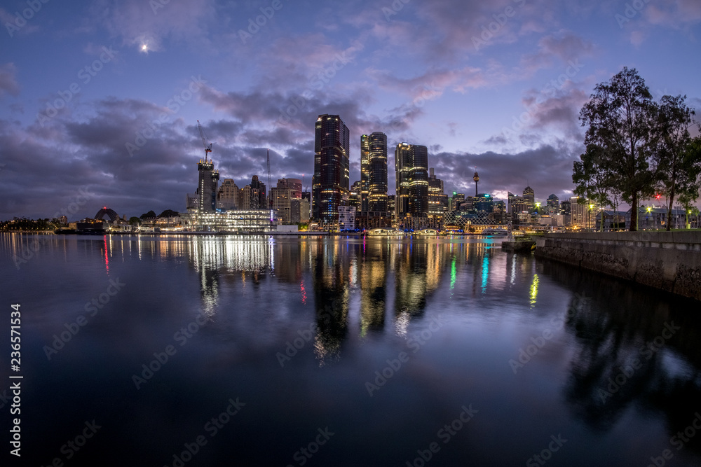 Sydney City under a crescent moon and dawn clouds