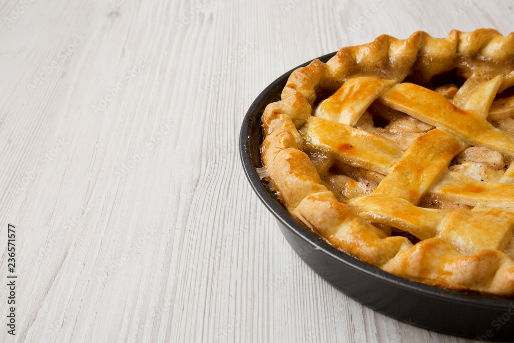 Homemade apple pie on white wooden table, side view. Copy space and text area. Homemade apple pie on white wooden table, side view. Copy space and text area.
