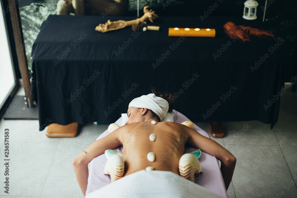 © Javier Pardina/Stocksy - Woman treatment at spa center.