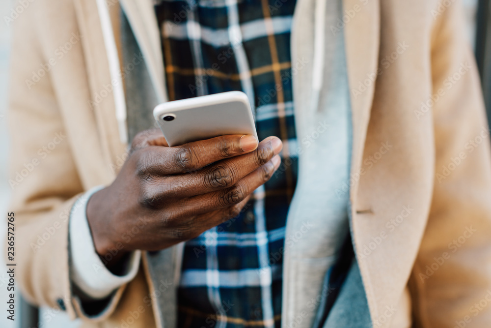 Closeup of a man using his phone outside in winter. Closeup of a man using his phone outside in winter.