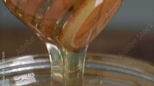 Honey Runs Down a Wooden Honey Spoon which goes Up, Extreme Closeup