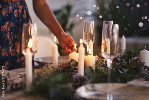 Lighting candles for christmas table setting  photo