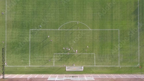 Corner kick - Top down aerial footage of a player kicking a corner kick at an amateur soccer match.