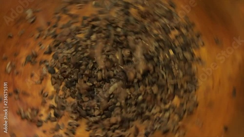 Cacao Nibs or Chips Falling into a Rotating Golden Cauldron, Closeup