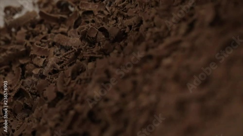 Chocolate is Grated and a Pile of Chocolate Shavings or Flakes Grows , Closeup