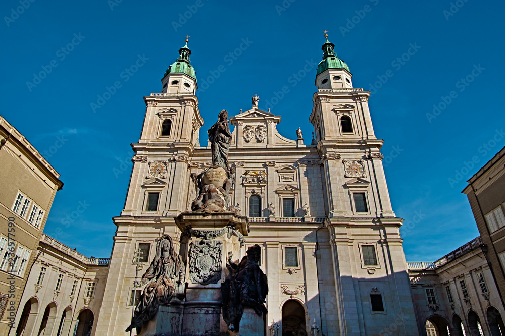 Fototapeta premium Salzburg Cathedral or Salzburger Dom with the fountain is the 17-th century baroque roman catholic church in Salzburg, Austria. Salzburg Cathedral is dedicated to St Rupert and St Vergilius
