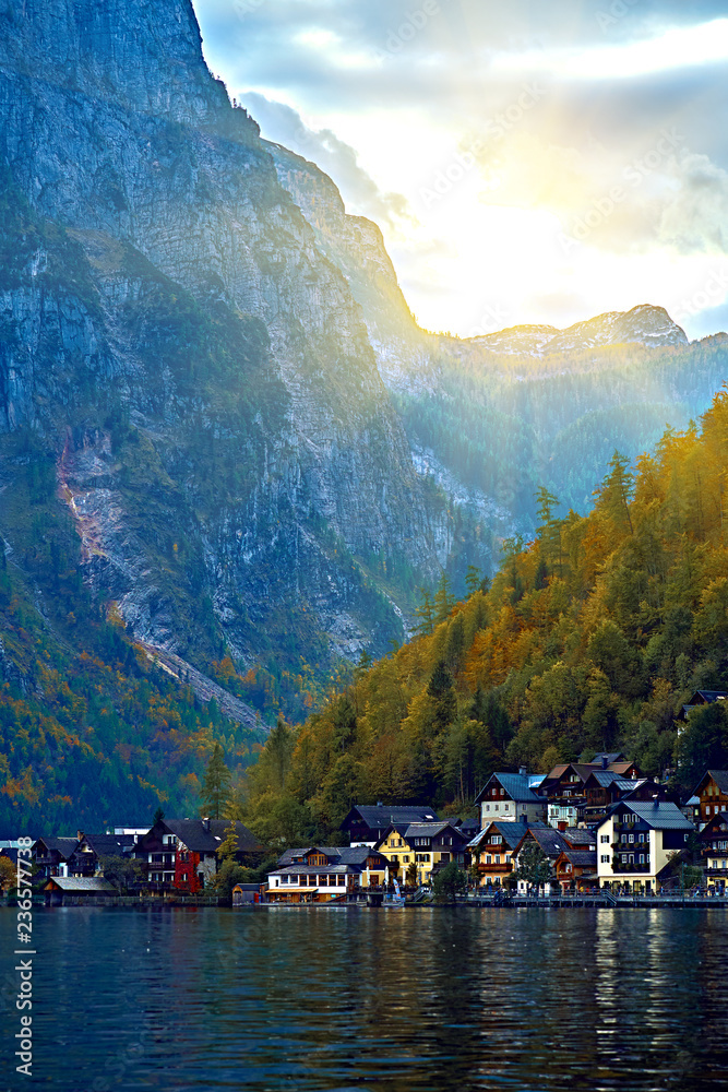 Sunset over Hallstatt austrian alps resort and mountain village with traditional rural alps houses, restaurants, hotels and wooden boat houses at Hallstatt lake. Location: Hallstatt lake Austria Alps