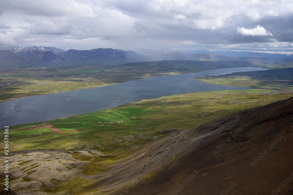Icelandic landscape. View from the top of the Svinadalsfjall to the lake Svinavatn. A mountain slide below.