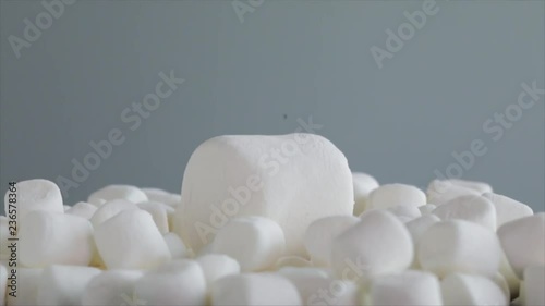 A big Marshmallow falls on a bunch of small Marshmallows, they wobble like pudding