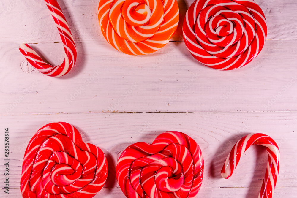 Different sweet lollipops on a wooden table. Top view Different sweet lollipops on a wooden table. Top view