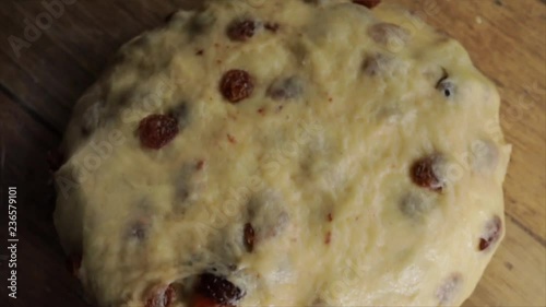 Dough of a Fruit Loaf or Stollen lies on a Wooden Table, Focus Rotates, Closeup.