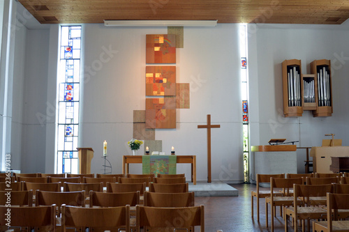 Paul-Gerhardt-Kirche in Plochingen with interior (nave), altar, crucifix and  artistic formed windows