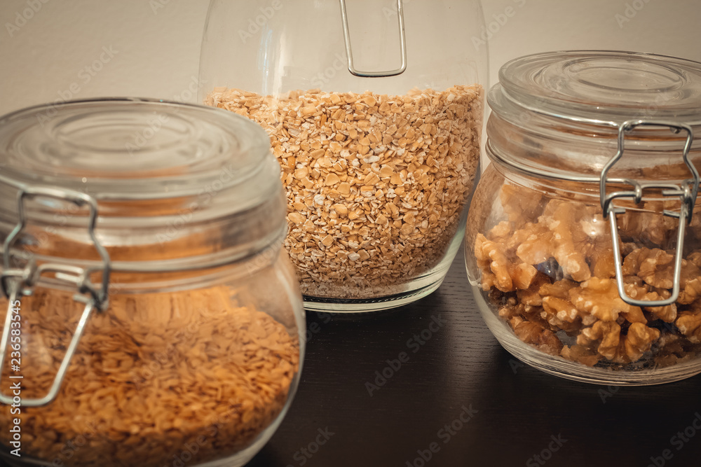 Healthy food, nuts, linseed and oats in glass jars Healthy food, nuts, linseed and oats in glass jars