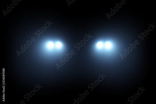 Car head lights shining from darkness background