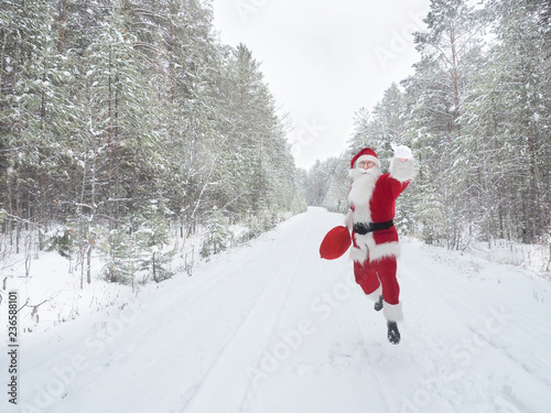 Santa Claus is walking along a snowy country road © arsenypopel