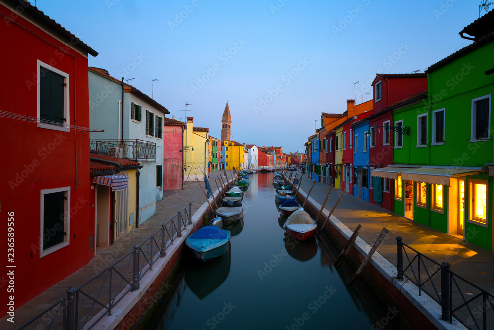 Old colorful houses and boats at night in Burano, Venice Italy