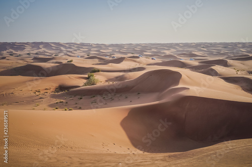 Off-road vehicles driving in the desert sand dunes of Dubai. 4-wheel jeep safari.