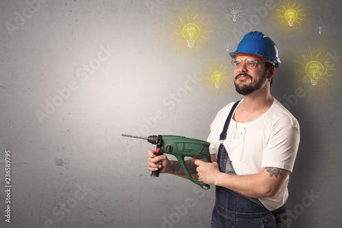 Craftsman with tool and new idea symbol in his hand. photo