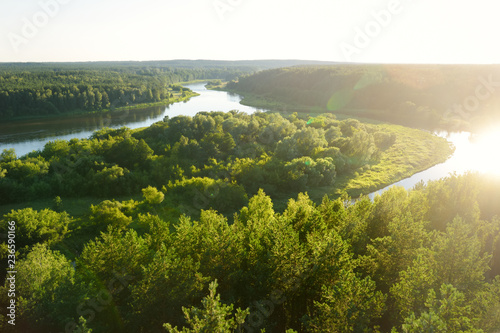 Scenic view from Merkine observation tower to Nemunas river, streaming between dense pine forests. photo