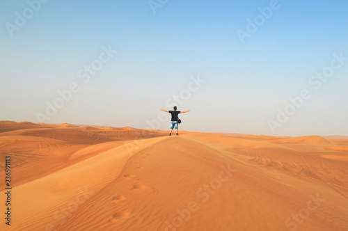 girl in the setting sun in the desert
