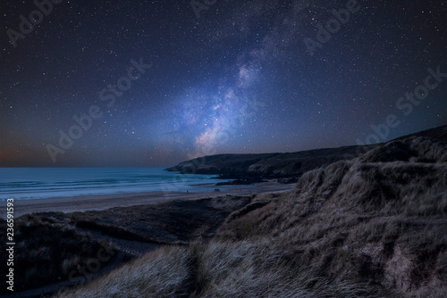 Vibrant Milky Way composite image over landscape of Freshwater West beach in Pembrokeshire Wales © veneratio