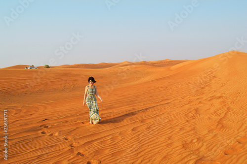 silhouette of a girl in the setting sun in the desert in the United Arab Emirates