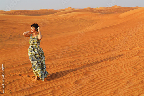 silhouette of a girl in the setting sun in the desert in the United Arab Emirates