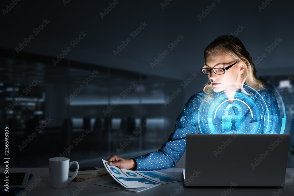 Beautiful blonde in dark office working on laptop and getting net access Beautiful blonde in dark office working on laptop and getting net access