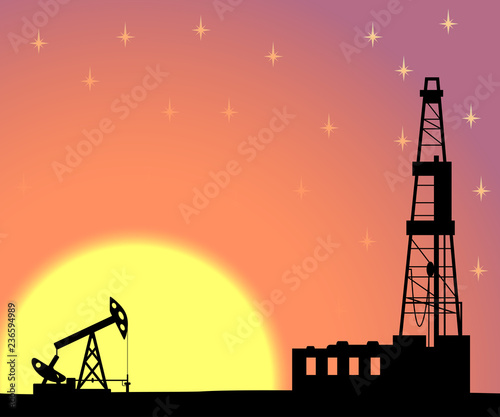 Silhouette of drilling rig and pump.