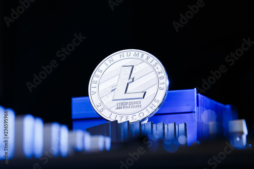 Photo of crypto currency litecoin and processor on blue background photo