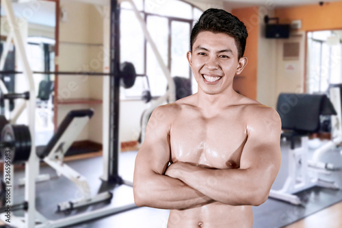 Muscular man looks confident in gym center