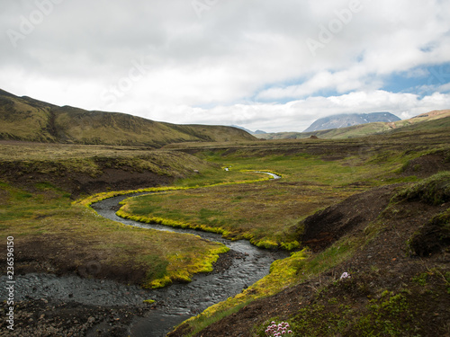 A beautiful river with a green moss and hills in clouds. Iceland, perfect destination for hikers. The Legendary Laugavegur Trek.