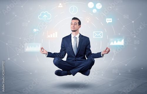 Elegant calm businessman levitates in yoga position with data circulation concept 