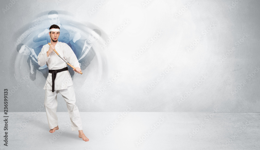 Young businessman in suit fighting with empty wall background
Young businessman in suit fighting with empty wall background