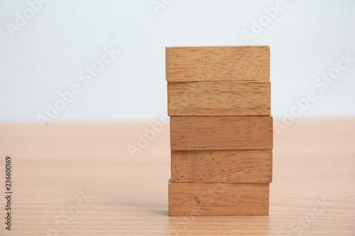 Stack of wooden block on table.