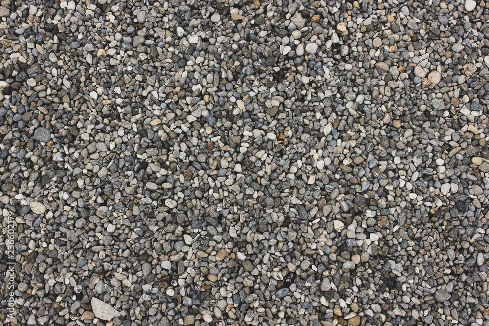 Gray and white natural sand and stones texture of ground. Dotted grey rock floor with place for text Gray and white natural sand and stones texture of ground. Dotted grey rock floor with place for text