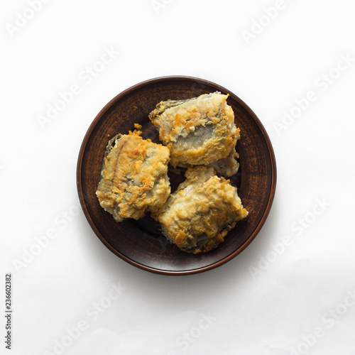 Delicious fried fish on white background, top view, flat lay