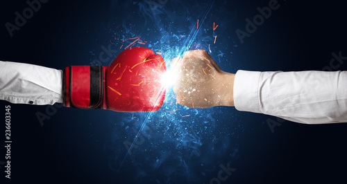 Two hands fighting with light, glow, spark and smoke concept   © ra2 studio