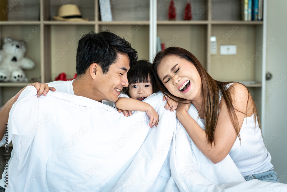 Happy family relaxing in bed. Happy family relaxing in bed.