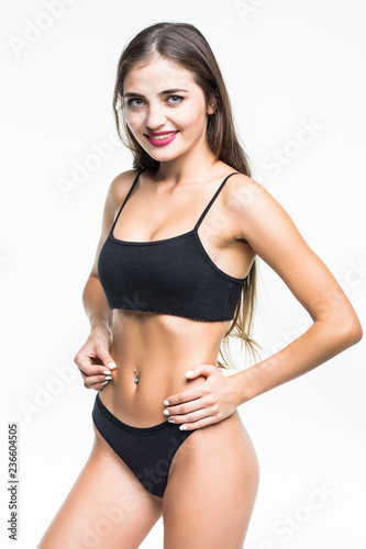 Woman in black swimsuit with perfect abs, fit body isolated on white background