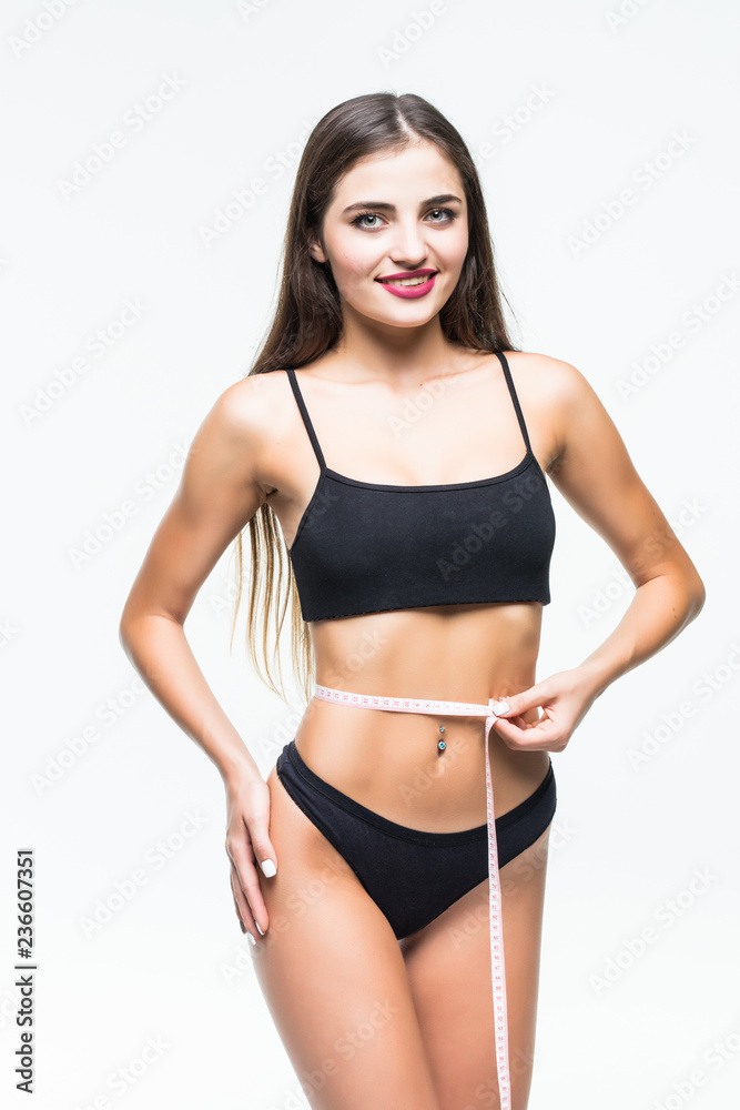 Fototapeta premium Beautiful young woman with measuring tape, isolated on white background