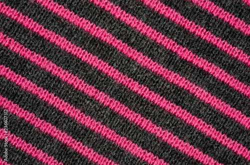 The texture of the wool fabric in black and red stripes