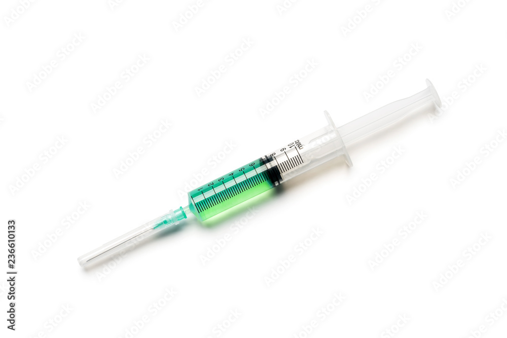Syringe with green liquid on white