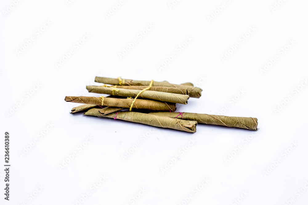 Close up of bidi or thin cigar or small cigarette isolated on white. Close up of bidi or thin cigar or small cigarette isolated on white.