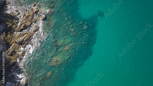 Aerial drone top view of transparent shallow water and sea ocean surface
