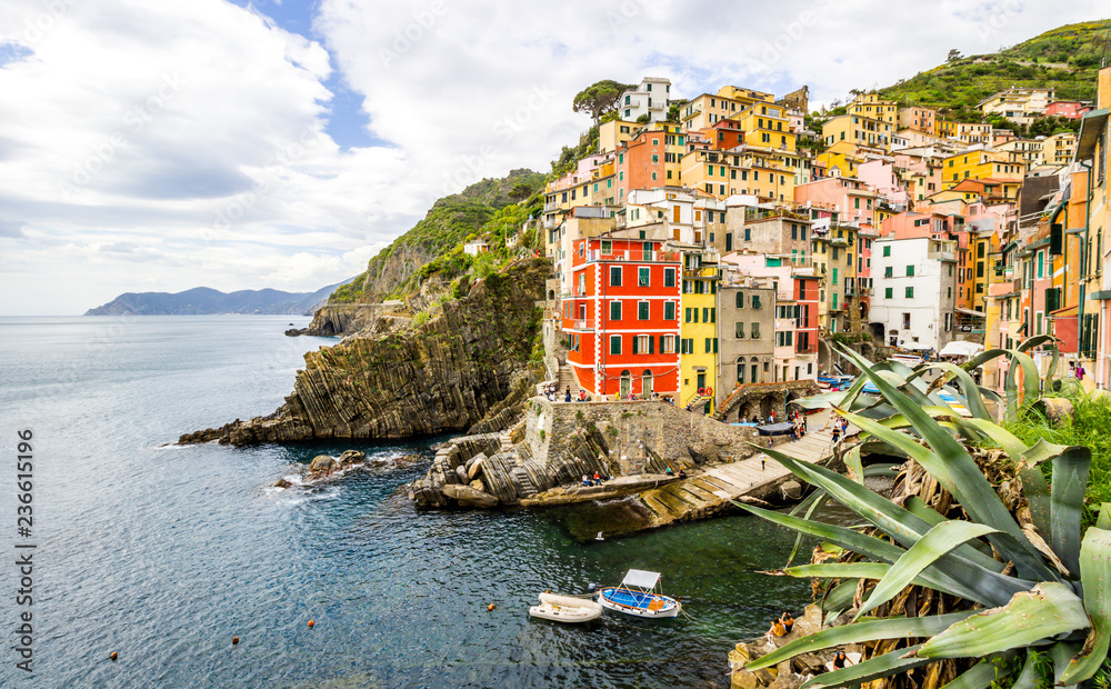 beach streets and colorful houses on the hill in Riomaggiore in Cinque Terre in Italy 