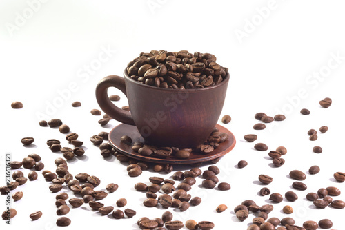 A cup with fresh coffee beans at the white isolated background.