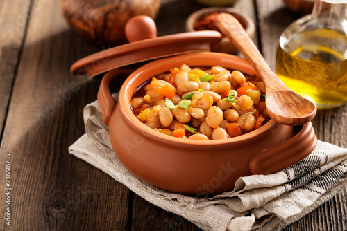 Obraz na plátně Baked beans in tomato sauce and greens.